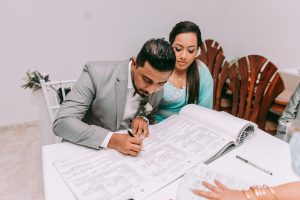 man in gray suit jacket sitting beside woman in teal long sleeve shirt