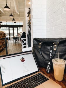 black leather handbag on brown wooden table